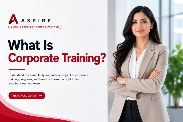 what-is-corporate-training-aspire-dubai.png Professional corporate training banner featuring a businesswoman in a beige blazer standing in a modern office, with Aspire branding and the headline “What Is Corporate Training?”